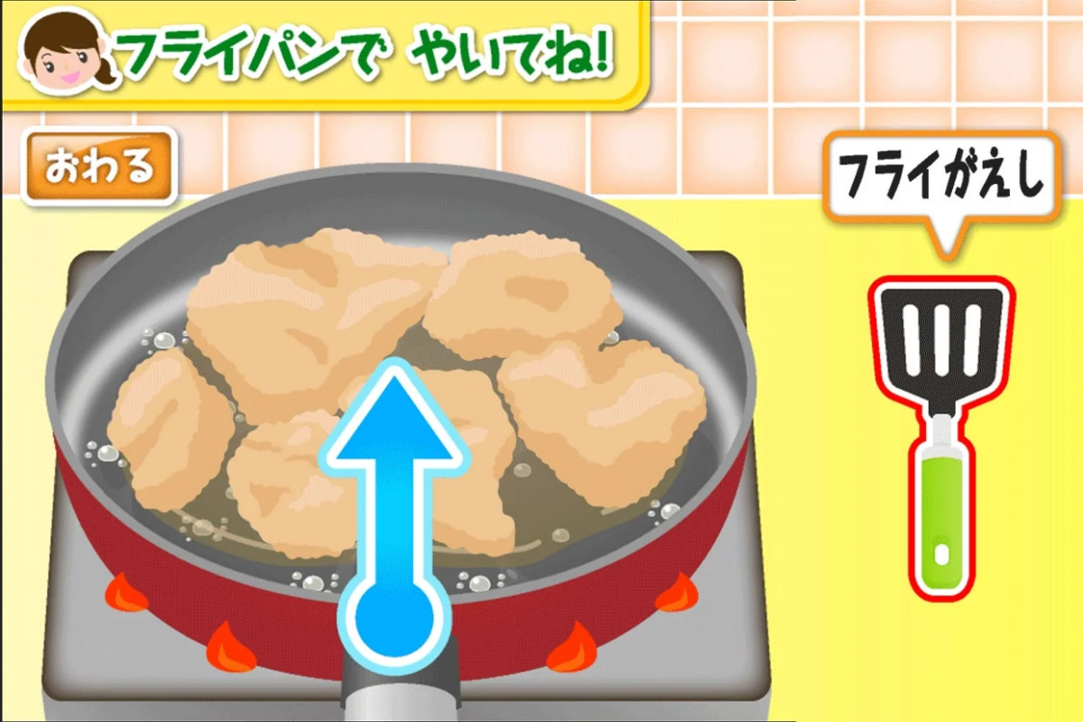 フライパンで揚げ物（または焼き物）を調理している様子が描かれた画像です。「フライパンでやいてね！」という指示があり、フライ返しも表示されていることから、料理ゲームや調理チュートリアルの一場面と考えられます。